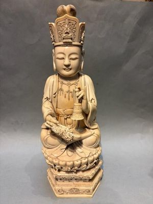 an image of a statue of a buddha with a crown on his head