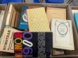 many books in a box on a table