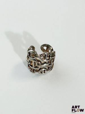 a close up of a ring on a white surface with a shadow