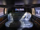 a picture of a car with two leather seats and a flat screen tv