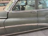 an old car that is parked on the side of the street