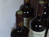 several bottles of wine are lined up on a shelf
