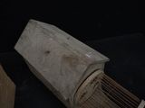 a bird cage with a bird inside of it on a table