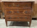 a wooden chest of drawers with marble top and drawers