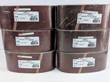 four rolls of brown tape are stacked on top of each other