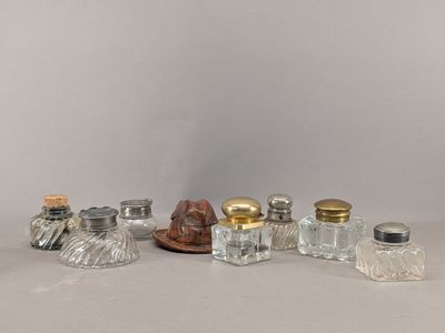 five glass salt and pepper shakers sitting on a table