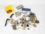 a pile of assorted jewelry on a white surface