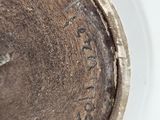 a close up view of a brown vase with writing on it