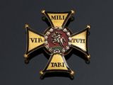 an image of a gold and black cross with a red and white emblem on it