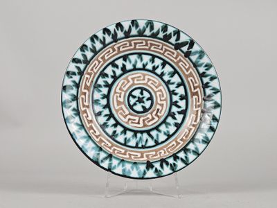 a blue and white plate with a circular design on it