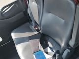 a seat in the back of a car with a cell phone in it
