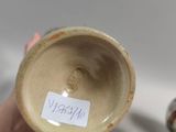 a person holding a cup with a sticker on it