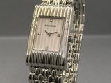a close up of a wrist watch on a clear stand
