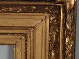 a close up of a gold frame with a bird on it