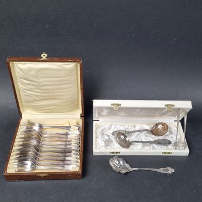 silverware in a box with a spoon and spoon rest in it