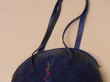blue leather purse with red and green embroidery on it