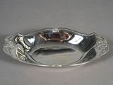 a silver plate with a gold decoration on it