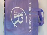 a purple bag with a logo on it sitting on a table