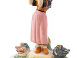 a figurine of a woman with a basket on her head