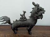 a small statue of a horse on a wooden table