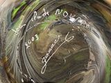 a close up of a vase with writing on it