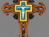 an ornate wooden cross with a blue and yellow cross on it