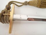 a close up of a knife with a rope attached to it