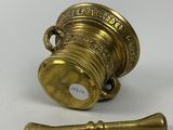 an image of a brass cup and a hammer on a white surface