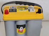 a yellow and black car battery sitting on top of a white counter