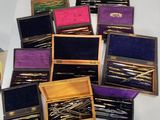 many different types of pins in a box on a table