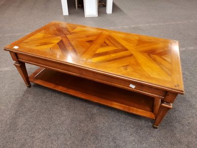 a wooden coffee table with a shelf underneath it