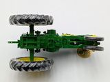 a toy tractor that is sitting on a white surface