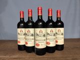 six bottles of red wine are lined up on a wooden table