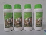 four bottles of horse feed sitting on a table next to each other