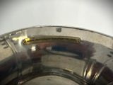 a close up of a metal bowl with a sticker on it