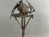 une sculpture représentant un oiseau perché au sommet d'un arbre