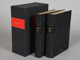 a pair of black books sitting on top of each other