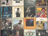 an image of a collection of various vinyl records on a wall