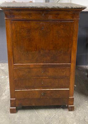 an old wooden chest of drawers with granite top in a room
