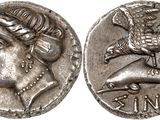 a silver coin with an image of a woman and a bird on it