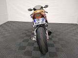 a motorcycle that is parked in a room with a checkered floor