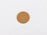 a close up of a coin on a white surface