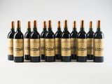 six bottles of red wine lined up in a row