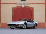 a silver sports car parked in front of a brick building