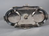 a silver plate with a silver handle on it