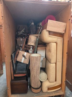 a wooden box filled with assorted items inside of it