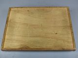 an old wooden box is sitting on a white surface
