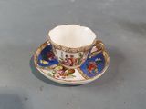 a cup and saucer sitting on a table