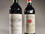 two bottles of red wine sitting next to each other on a table