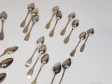 a lot of silver spoons and spoon spoons on a table